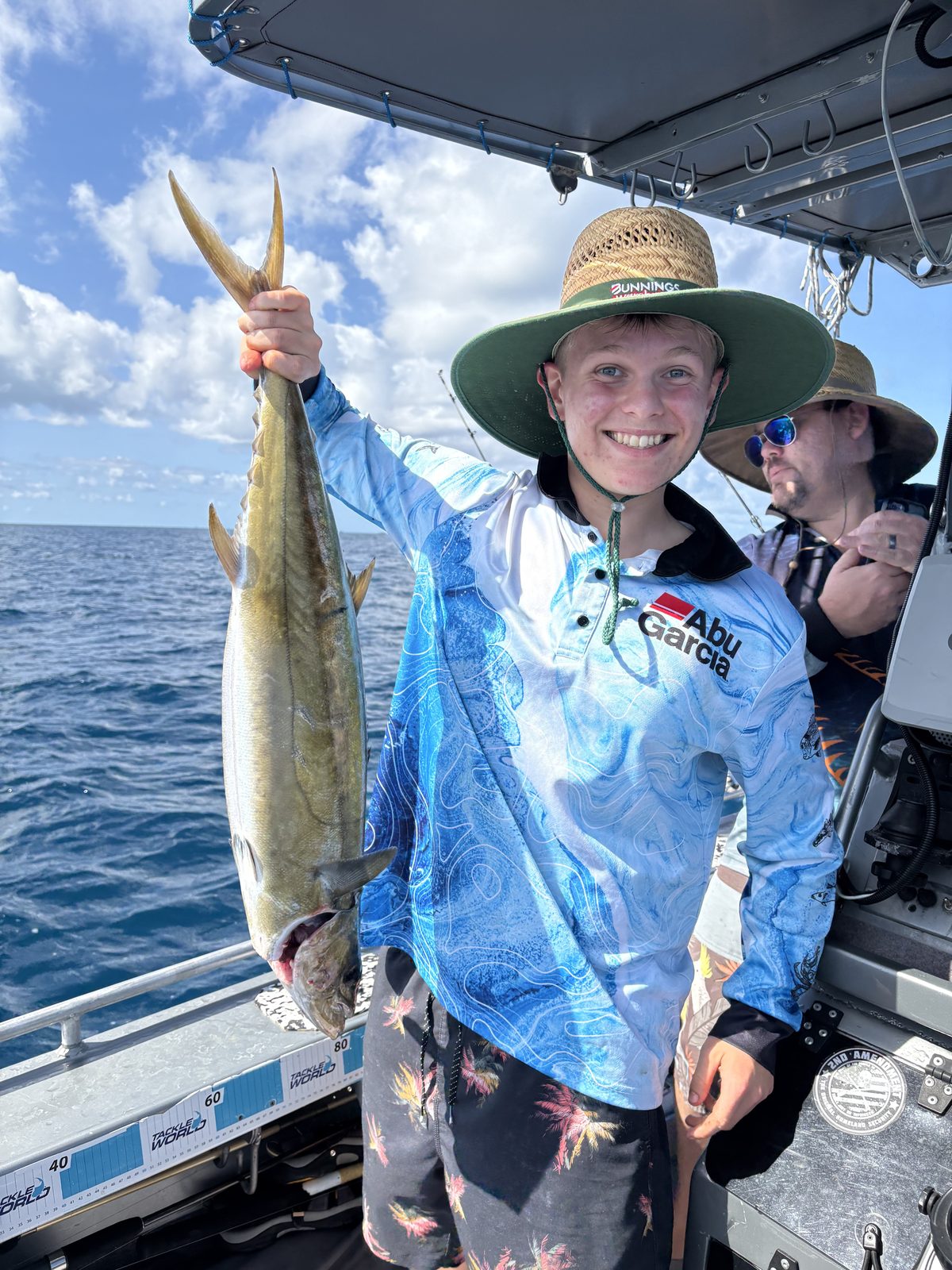 A shark mackerel held high